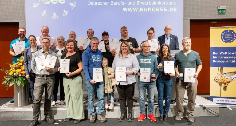 Belohnung für harte Arbeit und größte Sorgfalt: Die strahlenden Sieger des eurobee Honey Awards 2025 mit Urkunden und Medaillen für beste Honigqualität und ausgezeichneten Geschmack. (v.l.n.r. hinten: Johannes Fähnle, Mike Gerdes, Klaus Schmieder, Klaus Ahrens, Harald Aumeier, Martin Müller, Elisabeth Stolarczuk, Dr. Steffen Watzke, mitte: Ursula Lensing, Annette Seehaus-Arnold, vorne: Sven Bestmann, Helena Raff, Kilian und Anna Stumm mit Tochter, Jörg Homuth, Milka Pishmisheva, Oliver Leis). Foto: DBIB/Jan Gutzeit